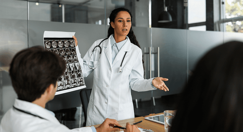 Female doctor presents x-rays to team